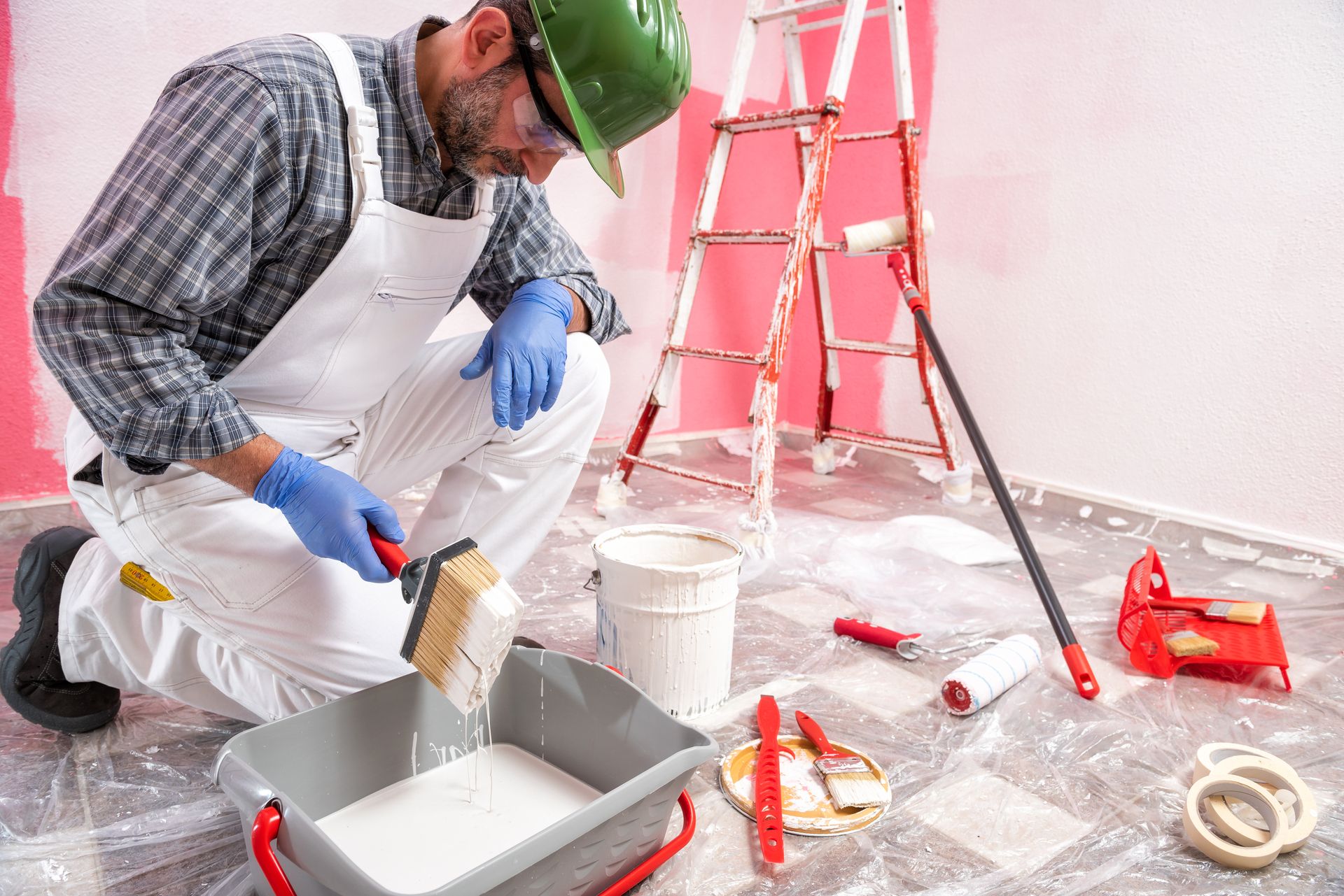 Commercial painter and decorator preparing paint in a tray